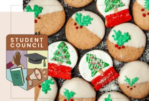 A plate of christmas cookies with the HCOS student badge