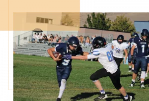 Football players running on field