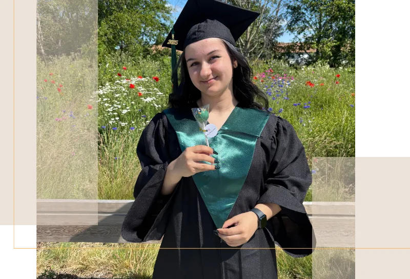 olivia b standing in a grad outfit