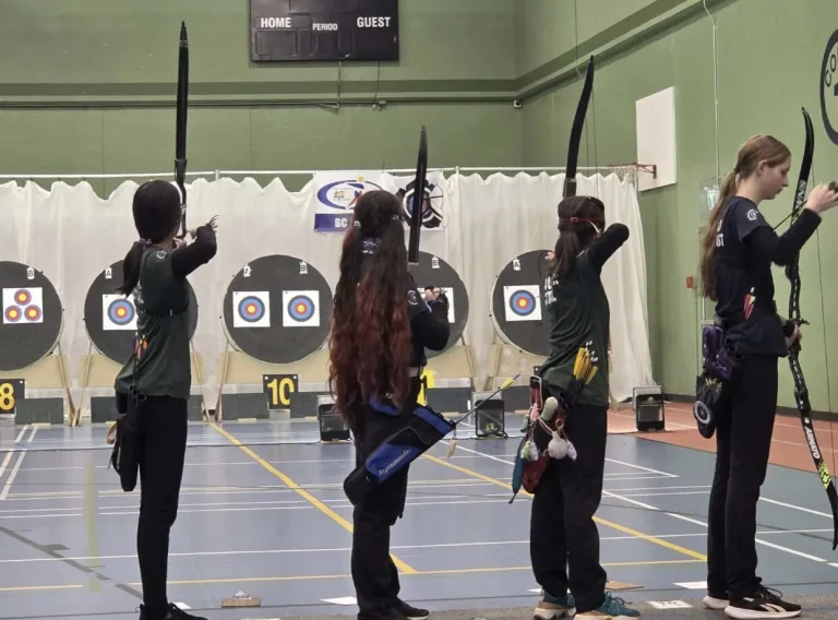 four archers taking aim at targets