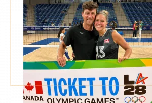 Brie standing with a Ticket to Olympic Games Banner