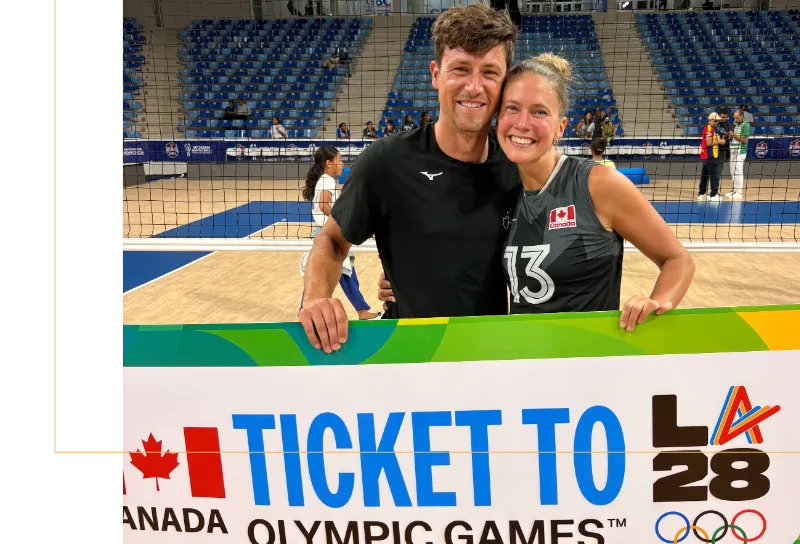 Brie standing with a Ticket to Olympic Games Banner