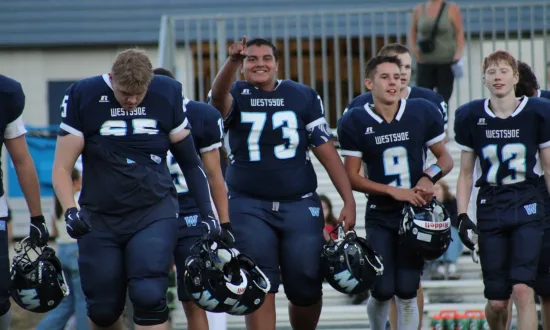 football players walking towards the camera and smiling
