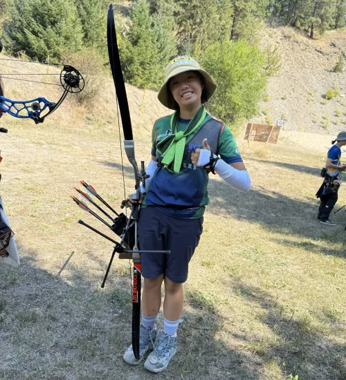 Lily Posing with her bow and a thumbs up