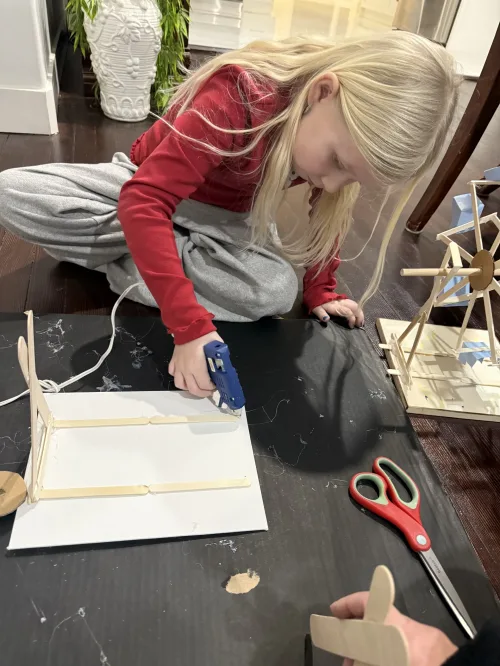 Aila using a hot glue gun